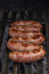 Grilled chorizos on a cuting board , typical Argentine sausages made with mixed pork and beef meat.