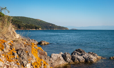 Beautiful panoramic view of the Black Sea with islands in the background. Rocky coast on a sunny summer day.