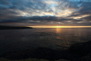 Fjord in Iceland with cooled volcanic lava rock at night,