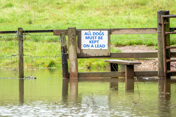 stile in the countryside surrounded by water in The River Hamble Country Park Hampshire England
