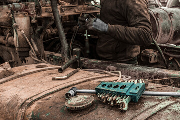 A bunch of car keys on the background of a truck with an open engine.