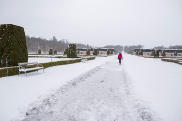 Swedish girl in Drottningholm park, Sweden. Caucasian tourist woman visiting Queen's royal residence in Stockholm, famous attraction in Sweden. Winter holiday concept.