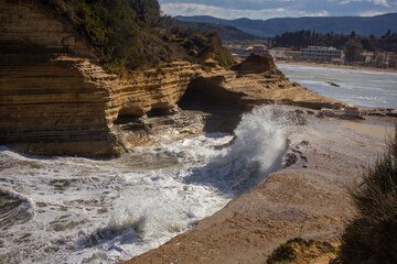 Cloudy and windy weather with large waves at the  beach in Peroulades, north Corfu island, Greece