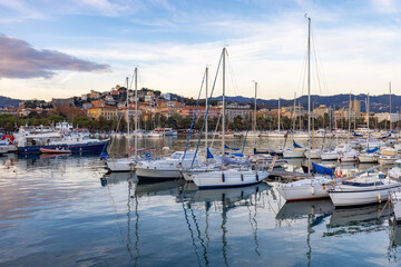 Boats at a marina in a touristic city, La Spezia, Italy. Sunset Sky.