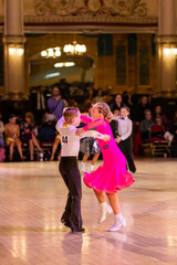 Attractive young couple of children dancing ballroom dance. Girl and boy dancer international...