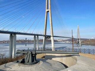 Guns of Novosiltsevskaya coastal batterie in Vladivostok fortress and Cable-stayed bridge, the Russkiy island, Vladivostok