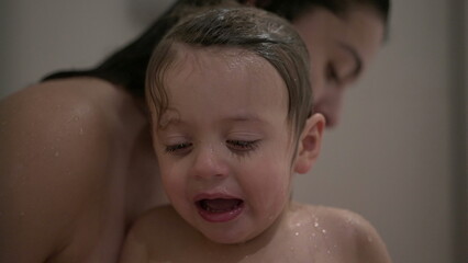 Mother washing baby toddler boy child bath