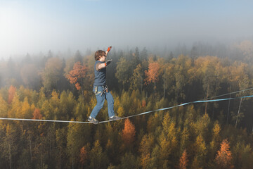 Tightrope walker against the backdrop of a stunning atmospheric forest
