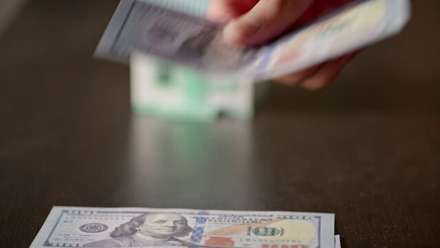 Footage close up of hands and fingers counting the cash banknote money for loan to buy new house.  