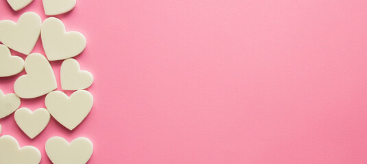 close up top view on white heart shape on pink color background for donation charity and valentine...