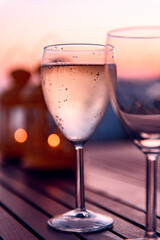 Cold house white wine served during holiday, amazing sunset as background