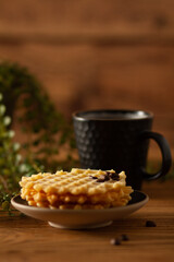 A transparent brown cup filled with citrus vitamin tea, a plate with citrus fruits in the form of tangerines