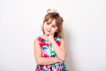 child girl in dress clothes on studio white