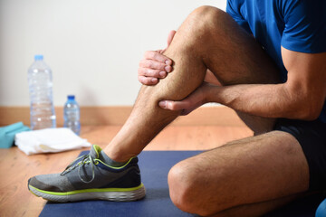 Detail of man doing sports with calf pain