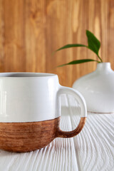 A cup with a warm warming drink on a wooden background