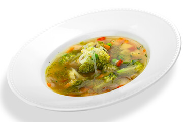 Close-up of tasty soup in white plate isolated on white background
