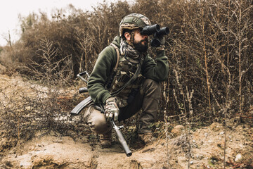 Soldier with binocular investigating the place