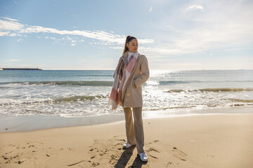 Portrait of a young pretty girl on the background of the sea