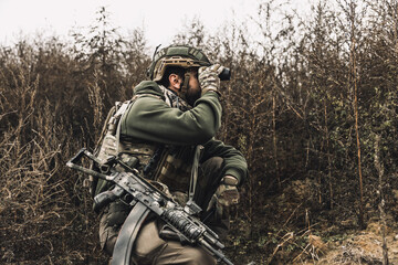 Soldier with binocular investigating the place