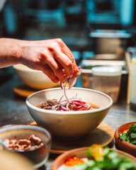 Hands of unknown chief serving with red onion meat steaks plate on restaurant background