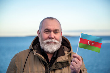 Man holding Azerbaijan flag. Portrait of older man with a national Azerbaijan flag. Visit...