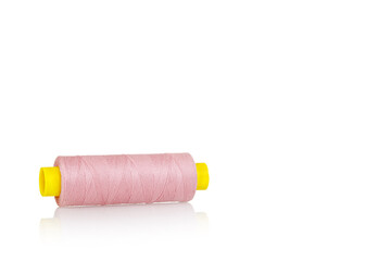 skein of thread pink colors macro on a white background