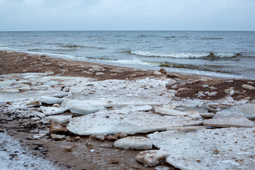 Seaside view at the Baltic sea with ice chunks in winter in January in Latvia