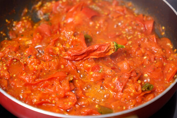Cooking process, stirring vegetables in chili sauce. Healthy food, vegetarian cuisine.