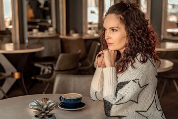 Woman cafe coffee breakfast. Portrait of an adult beautiful woman in an elegant suit in a cafe