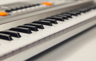 Black and white synthesizer keys. Selective focus, side view.