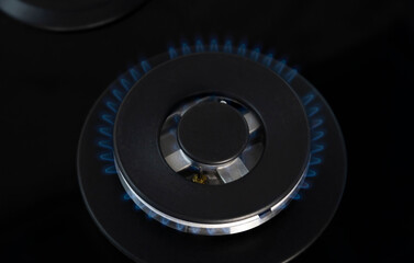 Gas flame close-up. Natural gas burns with a blue flame on the stove. Concept of gasification.
