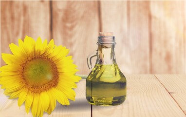 Sunflower oil in glass bottle and fresh flower