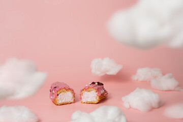 French eclair dessert, styled in white cotton clouds, pink color