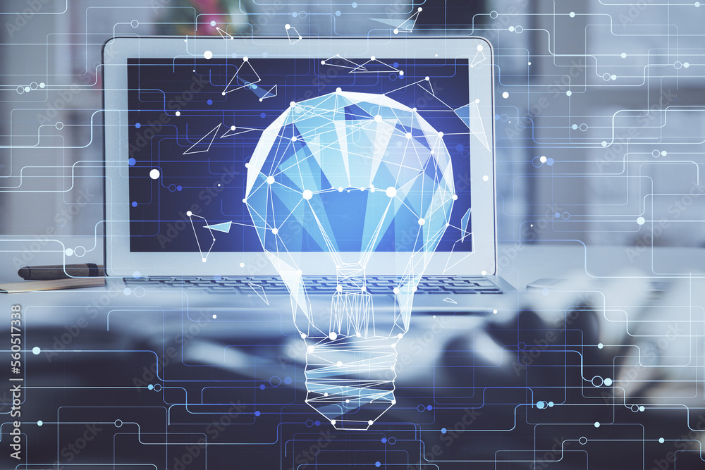 Poster Computer on desktop in office with bulb icon hologram. Double exposure. Concept of idea.