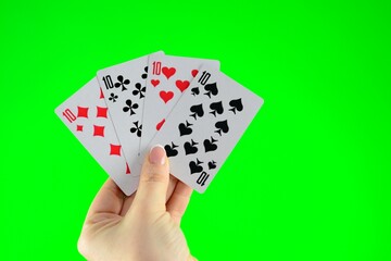 Hand holding four dozens on a green background close-up Tens in cards High quality photo