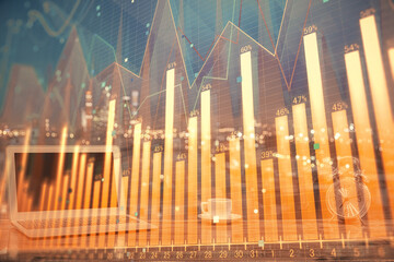 Financial chart drawing and table with computer on background. Multi exposure. Concept of international markets.