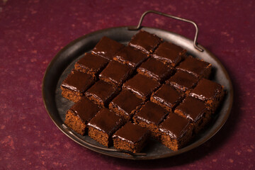 Delicious chocolate cake with chocolate frosting in a vintage metal tray