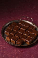 Delicious chocolate cake with chocolate frosting in a metal tray
