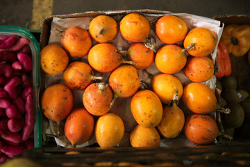 top view of box of yellow grenadillas in market for sale