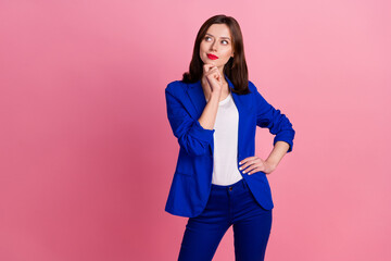 Photo of young genius intelligent business woman wear blue formal outfit touch chin hmm look empty space isolated on pink color background