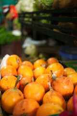 front view of box with pomegranates in the fruit and vegetable market for sale, selective focus