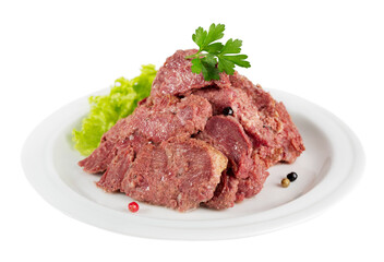 Canned juicy beef served on a plate with greens