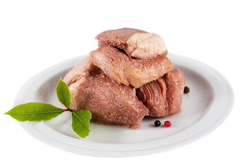 Canned juicy pork served on a plate with greens