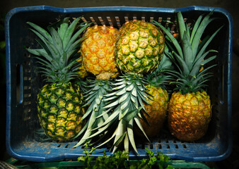 Basket full of pineapples for sale at farmer's market