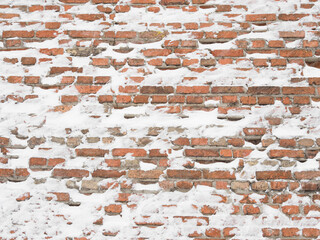 Snow-covered red brick wall. OLd Town in Lublin - obrazy, fototapety, plakaty