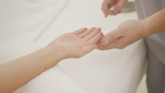 Close up of doctor's hand perform professional acupuncture treatment in beauty spa on woman's body