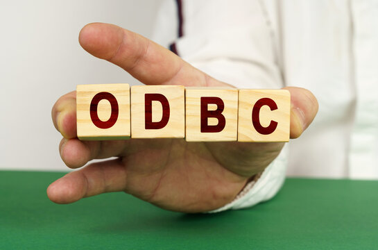 In the man's hand are cubes with the inscription - ODBC