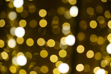 Abstract bright background, bokeh of burning yellow light bulbs.