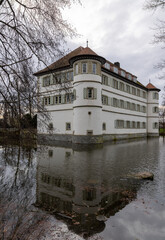 old moated castle of Bad Rappenau in winter with moat and reflection