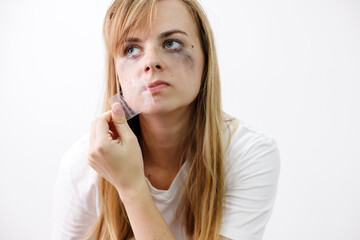 woman crying and tearing tape from her mouth